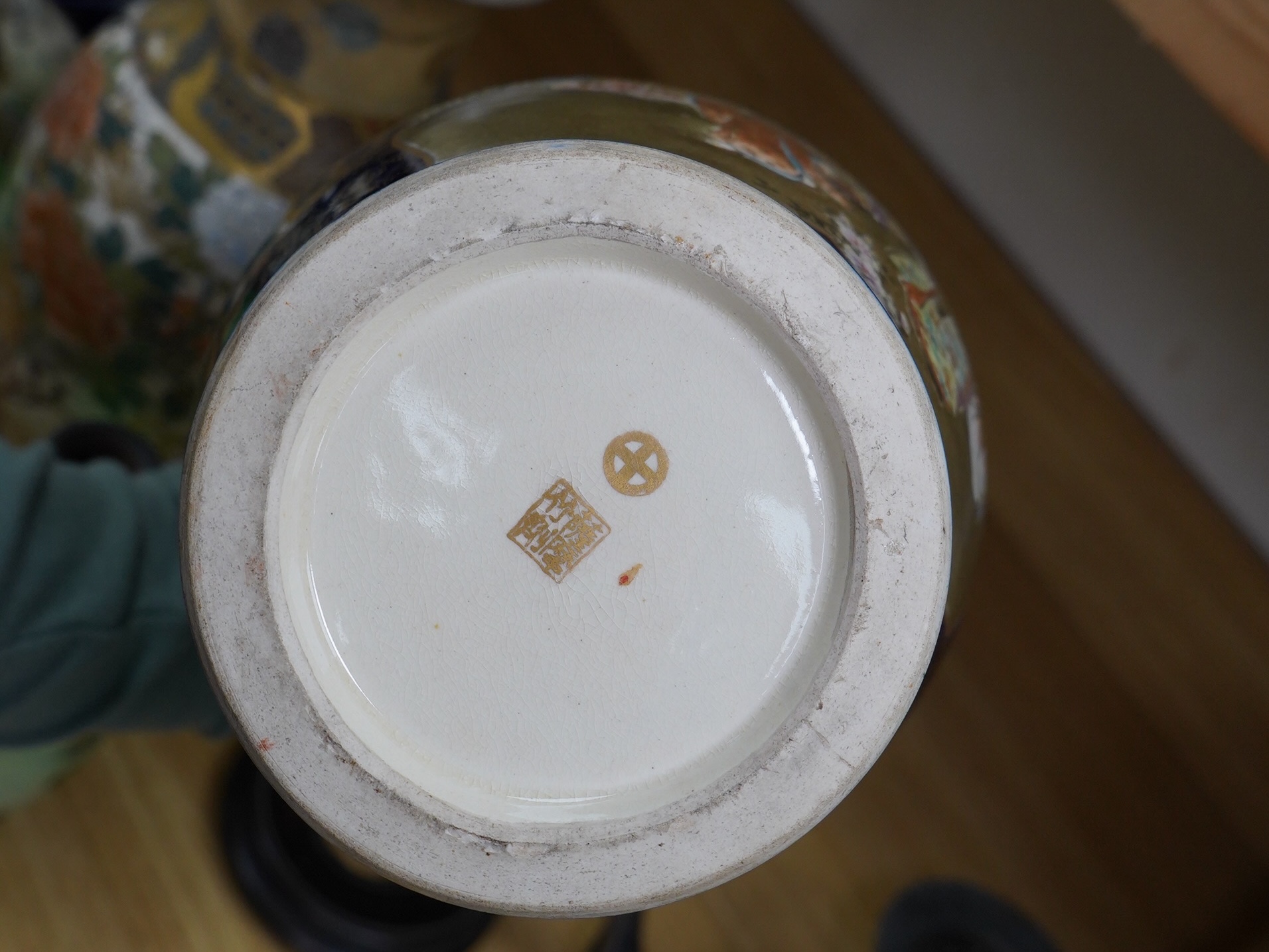 A pair of Japanese Satsuma vases on stands, a pair of floral enamel vases and another Satsuma pottery vase, largest 35cm high. Condition - poor